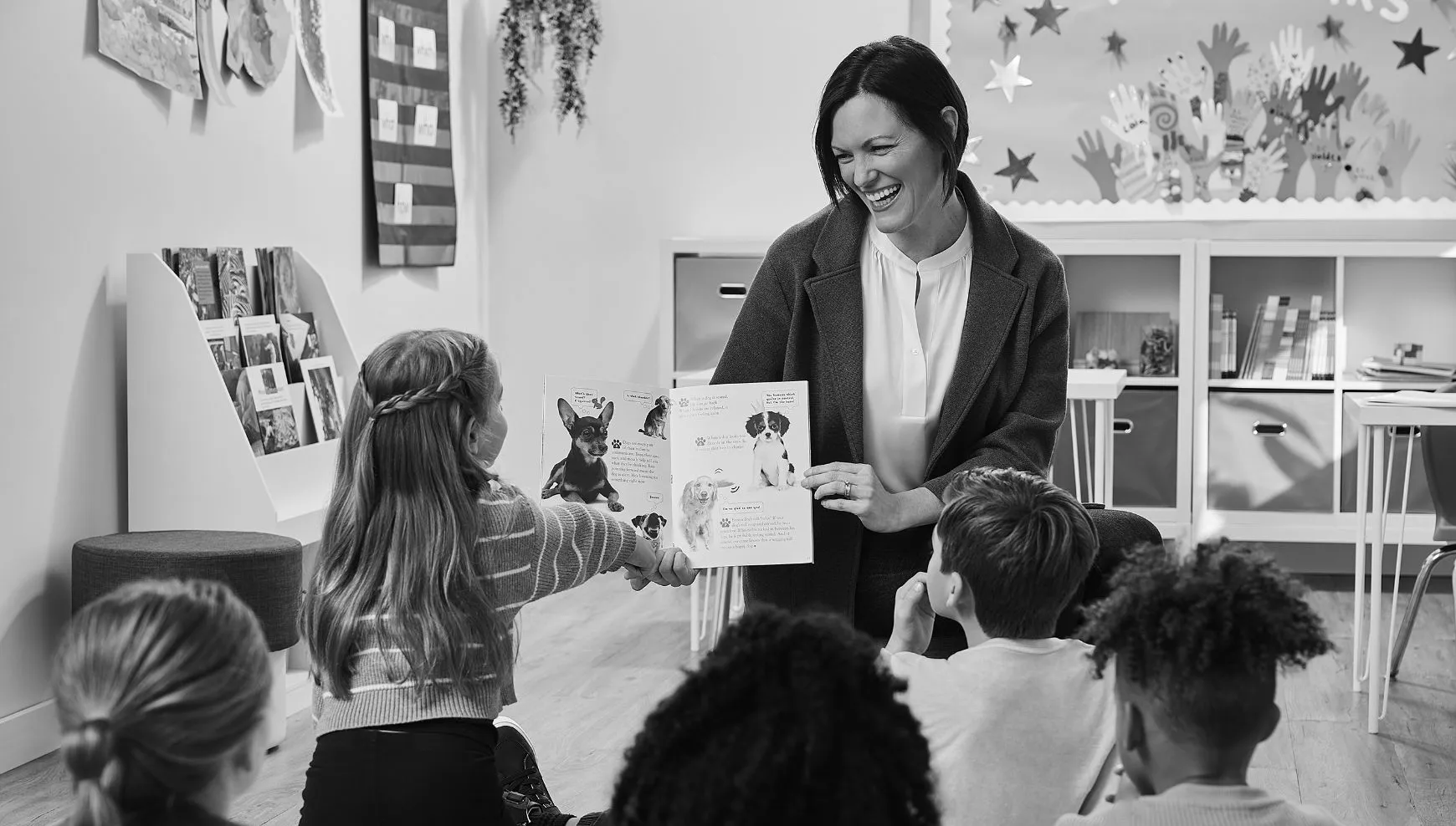 Woman reading a book to a group of children
