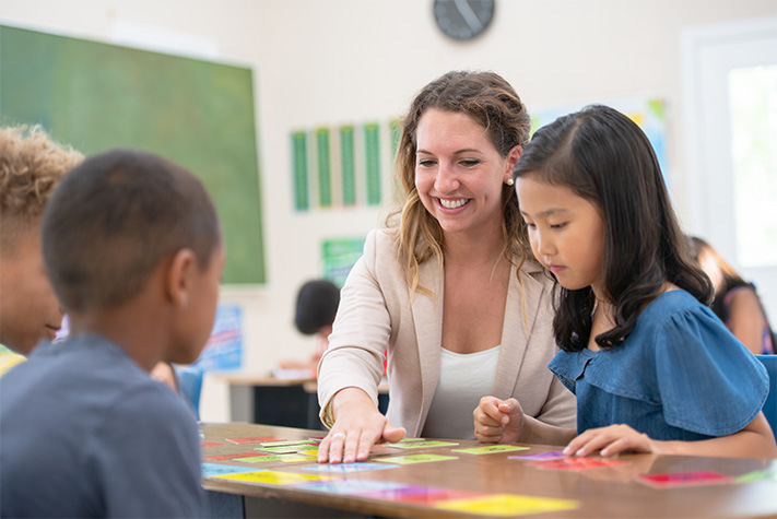 Students working with teacher in classroom
