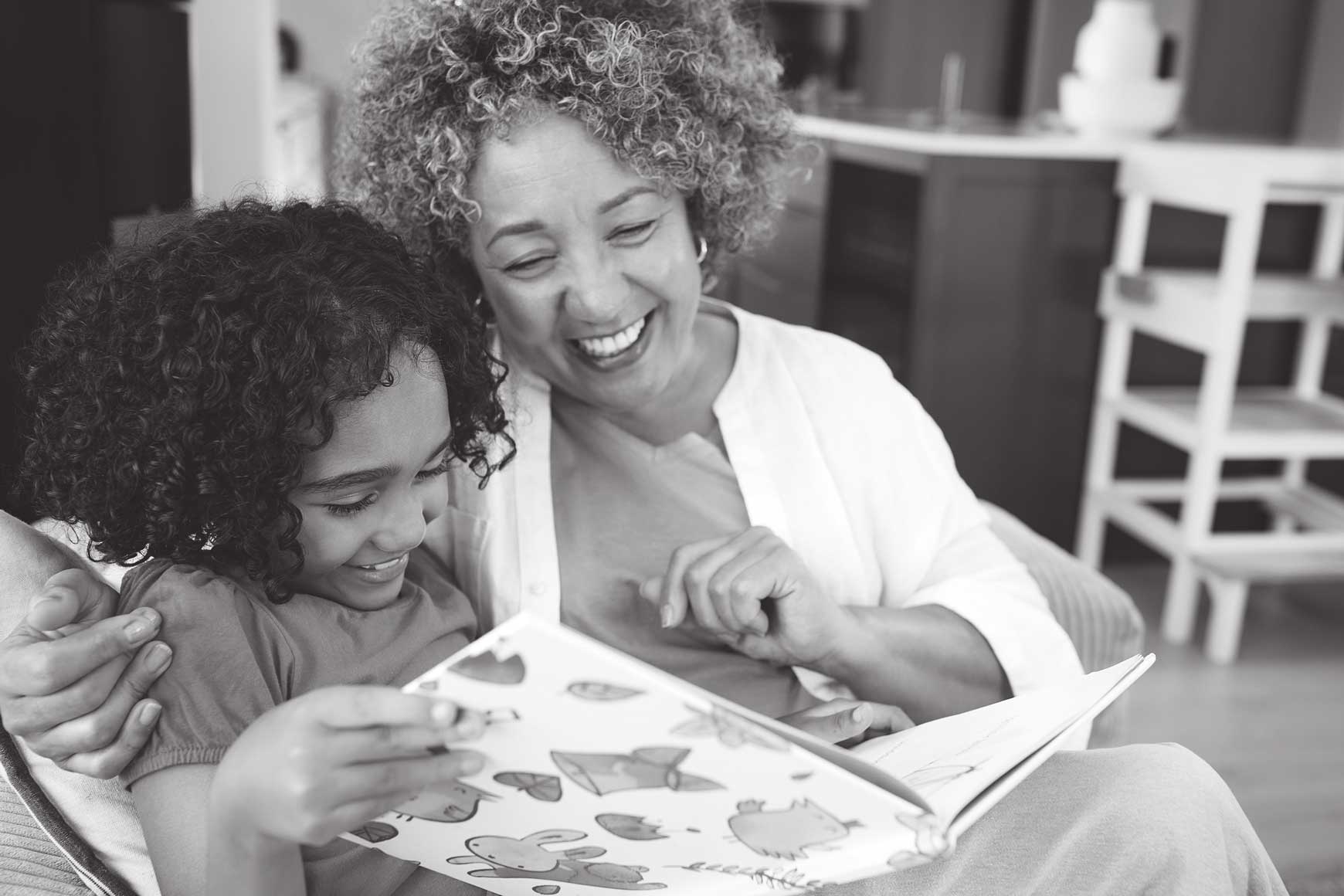 Woman and child reading a book together