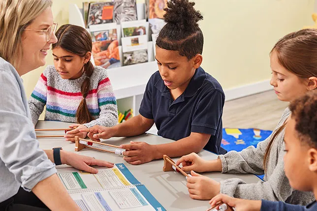 Small group of students led by a teacher engage in hands-on activity from Kickstart Number Sense.