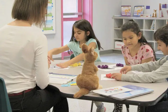 Three students participate in hands-on learning with Kickstart Number Sense author Jen Hunt