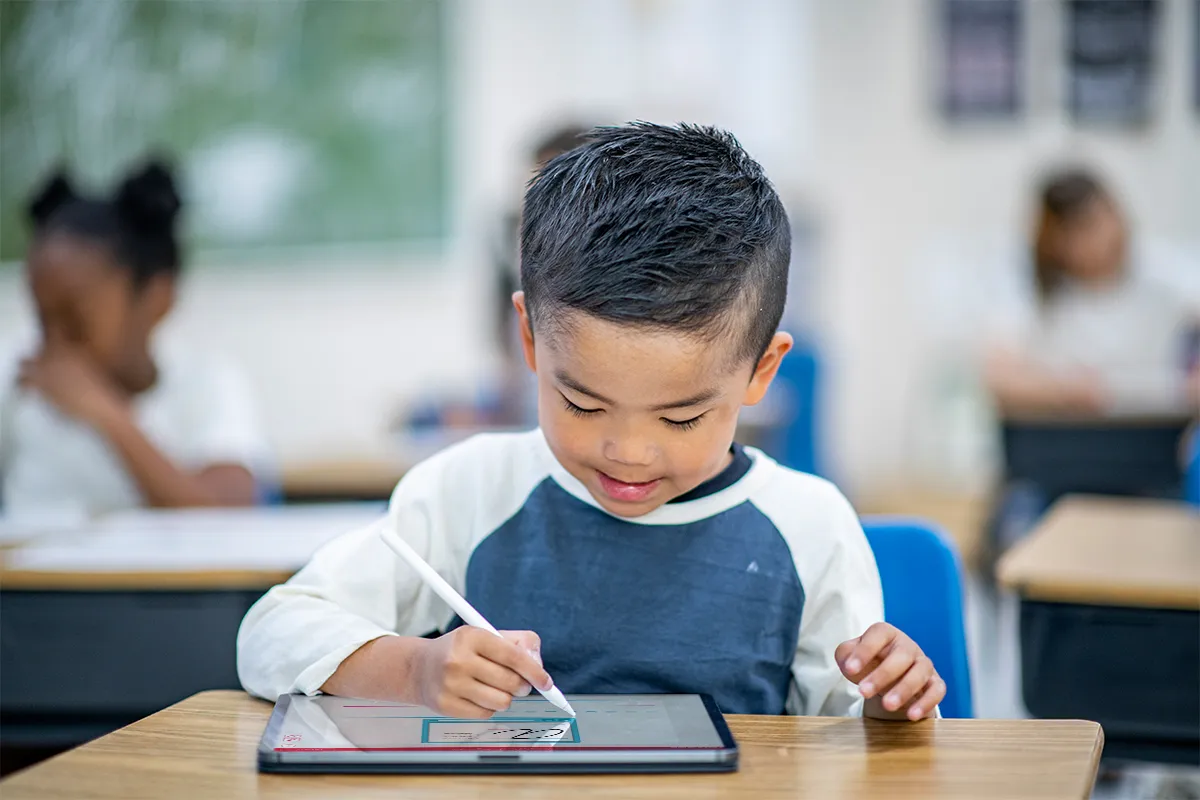Student practicing handwriting on a tablet with a stylus