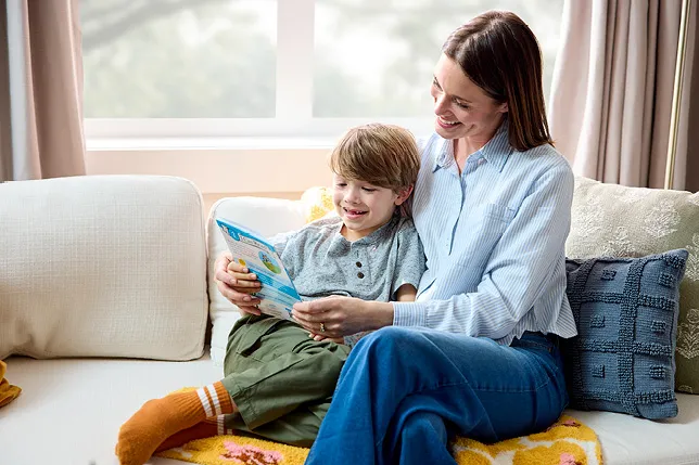 Parent and child reading Highlights I Can Read book together at home