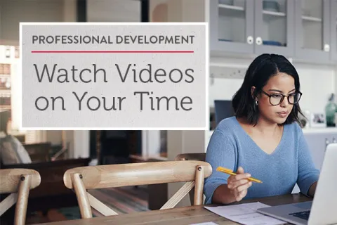 Teacher watching professional learning video on laptop at her dining room table