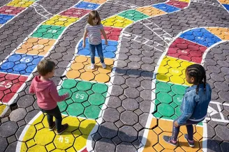 Three students explore a giant number line painted on playground